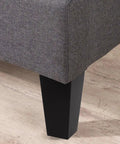4 Pack Black Wood and Iron Furniture Legs Replacement for Cabinets and Benches shown attached to grey upholstered furniture
