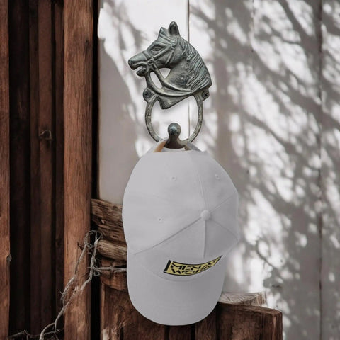 Handcrafted Cast Iron Horsehead Wall Hook With A Knockout Rustic Coffee Bean Brown Finish built like a tank, supporting a white cap.