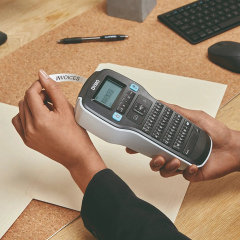 Badass Portable Label Maker Featuring Authentic Qwerty Keyboard And Rapid Response Touch Keys in use printing "INVOICES" label