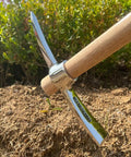Stainless Steel Double Headed Pickaxe With Wooden Handle For Digging Loosening Soil Transplanting Planting Camping And Prospecting A Real Yard Workhorse For Gardeners lying on soil