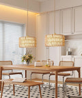 Level Up Your Chill Zone With This Hand Woven Rattan Plug In Pendant Light over a wooden dining table featuring a flower vase.