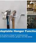 Hammers on wall-mounted adaptable metal hanger in workshop setting