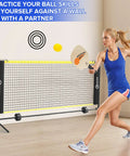 Woman playing with Six Foot Mini Pickleball Net Set With Quick Setup For Indoor And Outdoor Play Portable Practice Net