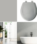 Ice Grey Round Toilet Seat With Slow Close And Easy Clean Hinges Durable Plastic Construction For Long Lasting Use Made In USA Modern Minimalist Look That Hides Stains And Reduces Noise In The Bathroom next to bathtub