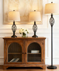 3 Piece Farmhouse Black Lamp Set With Oatmeal Fabric Shades Table Lamps And Floor Lamp, displayed on wooden cabinet in living room
