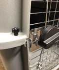 Close-up of pet carrier with installed Beefed Up Pet Carrier Bolt Fasteners Kit With Twenty Steel Carriage Bolts And Twenty Black Plastic Wing Nuts.