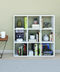 DIY Cube Organizer Shelf With Nine Cubes For Bedroom Living Room And Home Office In White Made In USA Easy To Assemble Sturdy Modular Storage For Books Decor And Plants, placed in a styled living room with decor items and plants.
