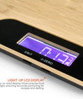 Close-up of bamboo cutting board with built-in digital scale for quick meal prep and precise weighing in grams and ounces 33 lb capacity