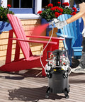 No Sweat Automatic Stirring Spray Paint Pressure Pot Two Point Five Gallon Air Powered Paint Mixer Tank with sprayer in use on patio.