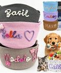 Stack of custom pet toy baskets with name embroidery in various colors, dog holding rope toy, and cat with basket of toys.