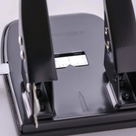 Close-up of Workhorse Two Hole Puncher For Paper With 30 Sheet Capacity Adjustable Guide And Locking Mechanism, black office tool.