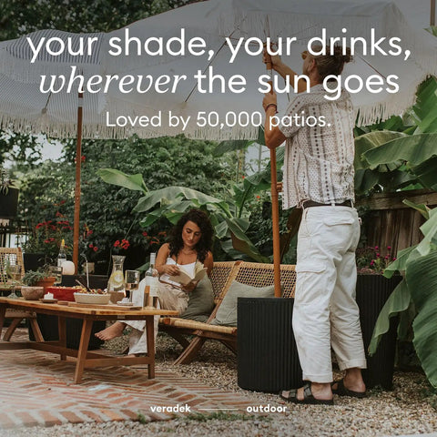 Outdoor scene with two people enjoying a patio with Durable Outdoor Umbrella Side Table With Umbrella Hole Package visible.