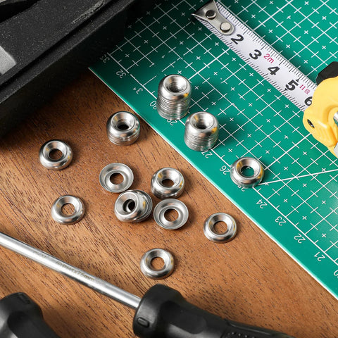 Front view of #8 countersunk finishing washers, 304 stainless steel, cup style, silver, on cutting mat with ruler