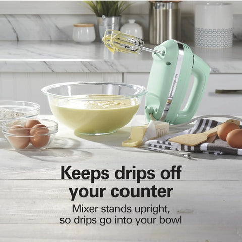 Retro 5 Speed Electric Hand Mixer With SmartBoost Tech And Powerful Dc Motor Designed For Effortless Mixing Whipping Dough And Creating Delicious Homemade Desserts This Slick Kitchen Gadget Rocks Smooth Operation For All Your Baking Needs. mixing batter in a glass bowl with eggs and butter on a countertop.