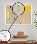 Wall Safe Pro Picture Hanger Set With Brass Padded Hooks shown mounting art above a bookshelf, close-up of hook detail