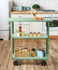 Flat Out Sturdy Three Tier Rolling Kitchen Cart Slick Green Metal Server with various items, 39x15x41 inches in kitchen setting.