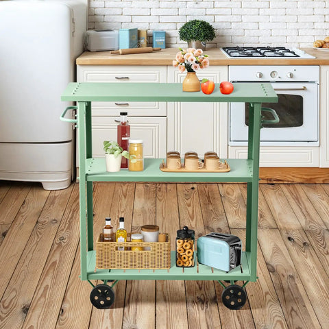 Flat Out Sturdy Three Tier Rolling Kitchen Cart Slick Green Metal Server with various items, 39x15x41 inches in kitchen setting.