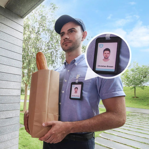 Delivery person holding a grocery bag at a front door, seen through Battery Powered Video Doorbell 2E With 2K Live View, Wide Dynamic Range.