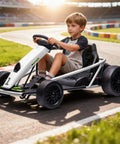 Child driving a white Ultra Powerful 24V Kids Go Kart with Dual 300W Motors on a track, outdoor ride-on vehicle for ages 8 to 12.