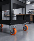 Close-up of 4pcs Inch M8 TPR Rolling Furniture Casters with Brake Orange mounted on a sturdy black cart in a workshop.