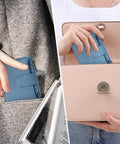 Woman placing compact everyday wallet for women with RFID blocking in a handbag, showcasing soft cowhide leather and slim design.