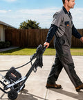 Gonna Save Your Arms For This Stand Airless Paint Sprayer 3000 Psi 650W being pushed on a wheeled cart by a man in a gray outfit.