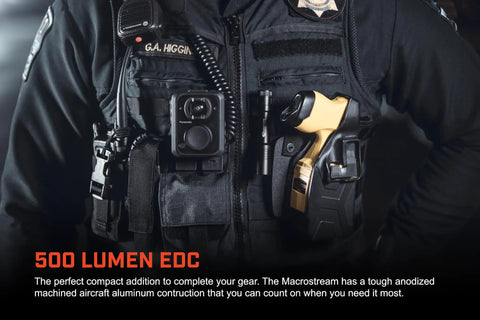 Officer wearing tactical vest with MacroStream USB Rechargeable EDC Flashlight With 500 Lumens And 2000 Candela Compact Pocketable LED Light That Fits In Your Pocket 90 Meter Beam 2 Hour Runtime USB Cable Included Black in holster.