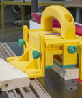 Kickback Buster 3D Push Block With Gravity Heel Kit For Table Saws, large yellow push block positioned on wood.