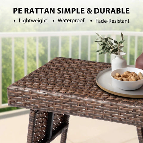 Portable Folding Wicker Table With Steel Frame For Outdoor Use close-up showing rattan surface and decorative items.