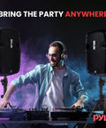DJ using Powerful Dual 8 Inch Active And Passive PA System Kit with 700 Watt Max Output, microphone, and stands for live gigs