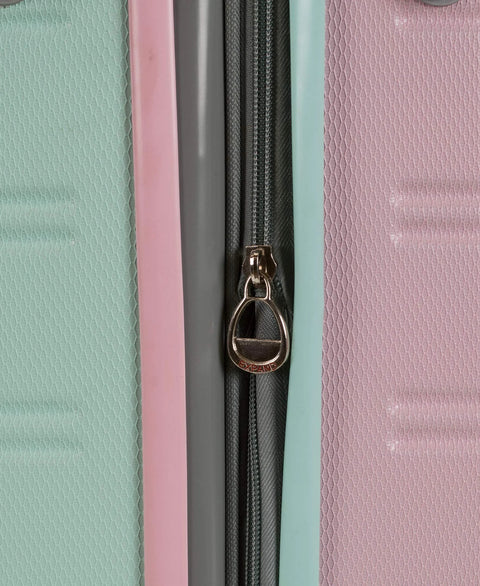 Close-up of mint carry-on hardside luggage with pink and teal panels and a visible zipper pull