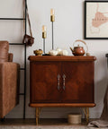 Wooden cabinet with decorative handles, surrounded by fall decor and a cozy room setting; no visible cabinet pulls from the product description.