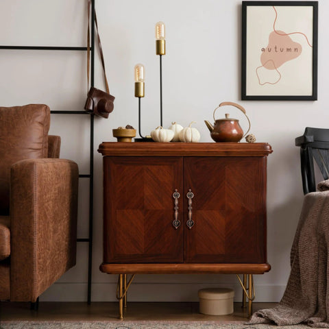 Wooden cabinet with decorative handles, surrounded by fall decor and a cozy room setting; no visible cabinet pulls from the product description.