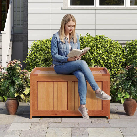 Woman sitting on Wood Deck Storage Box 52 Gallon For Patio Cushions And Pillows Garden Tools Pool Accessories And Outdoor Gear
