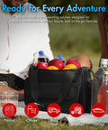 Portable Thermoelectric Cooler Warmer Bag 14 Liters filled with drinks and fruits during a picnic on grass.