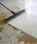 Built Like A Tank 30 Inch Silicone Floor Squeegee With Rust Resistant Stainless Aluminum Pole cleaning water off tiled floor.