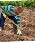 Man using Handheld Pitch Fork For Manure And Straw Cleanup, Lightweight Farm Fork, in the garden for quick cleanups