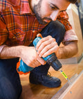 Person using 2-Pack Quick Release Magnetic Drill Bit Holder With One-Hand Swap on a wooden surface, close-up of drill and bit