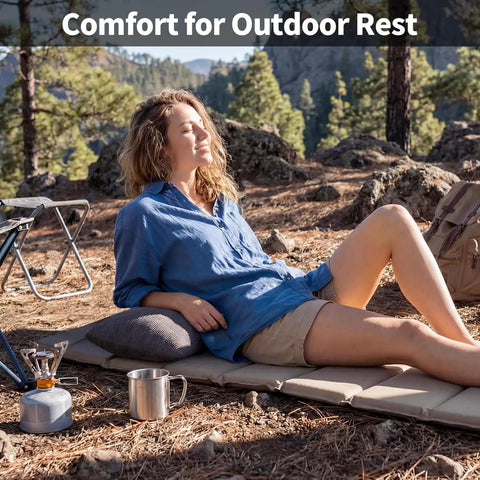 Woman using Two Pack Camping Pillows With Plush Fill And Washable Covers, relaxing outdoors on a mat, surrounded by camping gear.