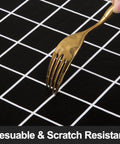 Close-up of a fork on a black tablecloth showing the Waterproof Elastic Fitted Vinyl Table Cover 30x72 With Flannel Backing