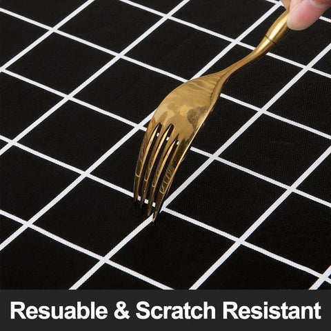 Close-up of a fork on a black tablecloth showing the Waterproof Elastic Fitted Vinyl Table Cover 30x72 With Flannel Backing