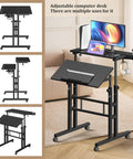 Rolling Standing Desk On Wheels With Height Adjustment Mobile Sit Stand Computer Desk in living room setup, screens and keyboard visible.