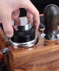 User adjusting the Top Shelf 58mm Espresso Distributor And Tamper Set, Dual Head Coffee Leveler for perfect brewing.
