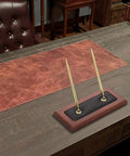 Wood And Leather Double Pen Holder Desk Set With Two Black Pens on executive desk, gold accents and luxury decor.
