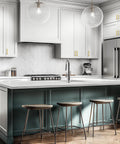 Modern kitchen with stainless steel appliances, island, and cabinets featuring brushed stainless steel cabinet handles with 3 inch center to center hole spacing.