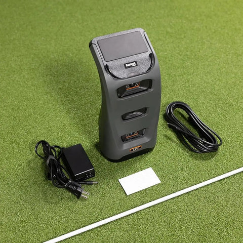 Launch Pro LPi Circle B Edition Indoor Golf Launch Monitor Bundle with portable charger, USB cable, and power cord on turf.