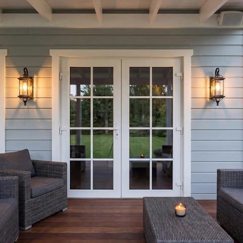 Solid Copper Outdoor Wall Light With Oil Rubbed Bronze Finish, 18.5 Inch Porch Lantern flanking patio doors, clear beveled glass, at dusk