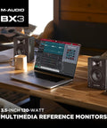 Pro Grade Wired Studio Monitors For PC With Three Point Five Inch Drivers Latency Free Audio next to a laptop on a desk