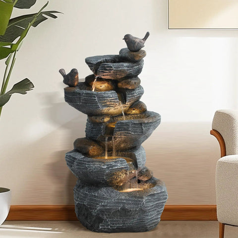 5 Tier Cascading Rock Water Fountain With LED Lights For Outdoor And Indoor Use, resin water feature in living room setting