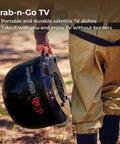 Person carrying Dish Playmaker Dual With Receiver Self Pointing Satellite Antenna For RVs And Outdoors Auto Satellite Acquisition